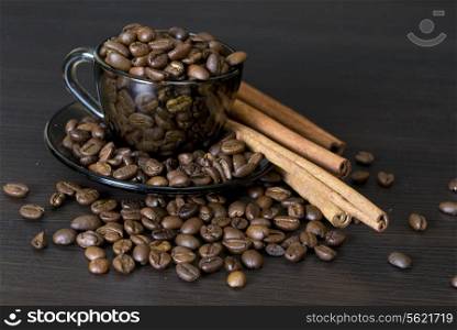 coffee beans in a cup on dark background