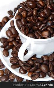 Coffee beans in a white cup overflows