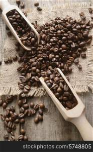 coffee beans in a wooden bowl on wooden background
