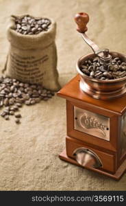 coffee beans in bag and coffee grinder