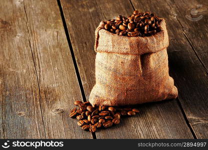 Coffee beans in bag on wooden table