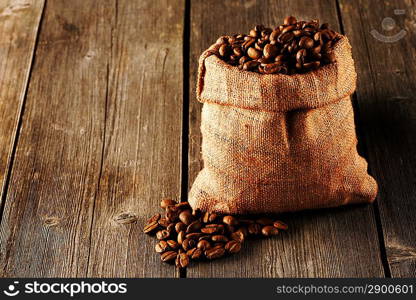 Coffee beans in bag on wooden table