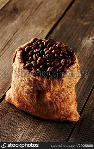 Coffee beans in bag on wooden table