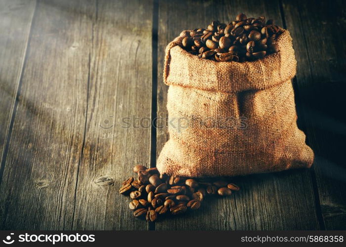 Coffee beans in bag on wooden table