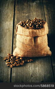 Coffee beans in bag on wooden table