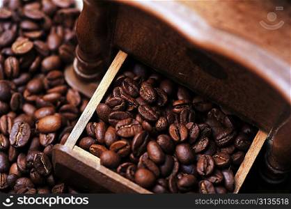 coffee beans in box from old hand grinder