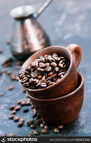 coffee beans in cup and on a table