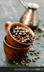 coffee beans in cup and on a table