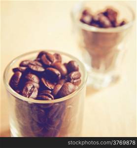 Coffee beans in glasses with retro filter effect
