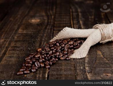 Coffee beans in linen cloth on wooden board