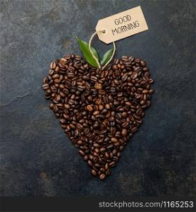 Coffee beans in shape of heart on dark rustic background, flat lay. Coffee beans in shape of heart on dark rustic background