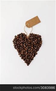 Coffee beans in shape of heart on white background. Coffee beans in shape of heart on white background, flat lay
