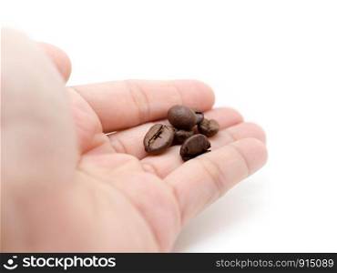Coffee beans in woman hand (plam) on white background.