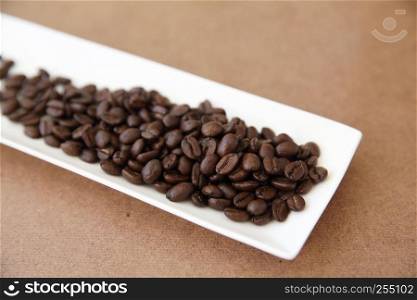 Coffee beans isolated in wood background
