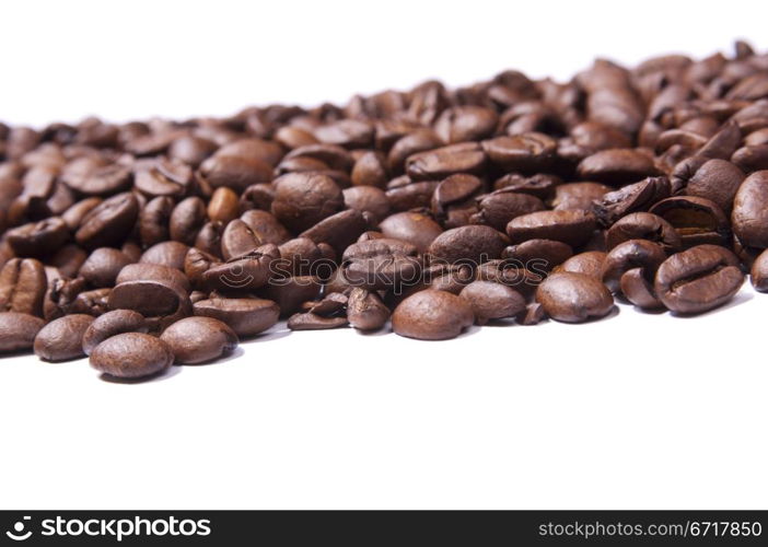 Coffee beans isolated over white in shallow focus