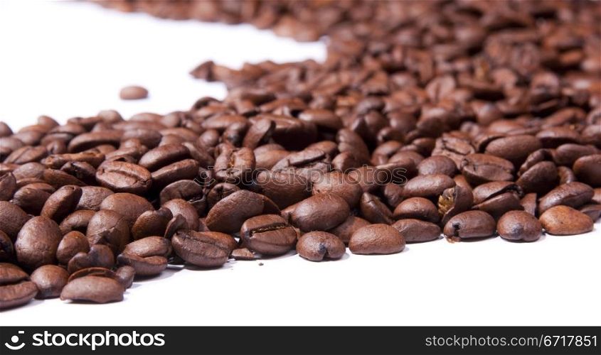 Coffee beans isolated over white in shallow focus