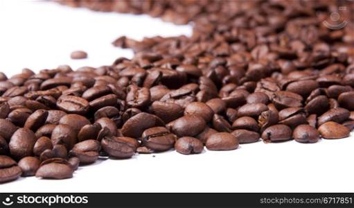 Coffee beans isolated over white in shallow focus