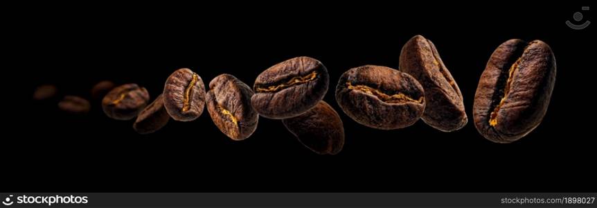 Coffee beans levitate on a black background.. Coffee beans levitate on a black background