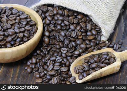 Coffee beans of the highest quality on the wooden table.