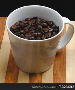 coffee beans on a cup on a wood board