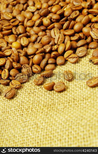 Coffee beans on a sack background