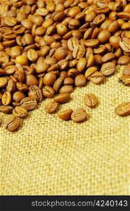 Coffee beans on a sack background