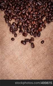 coffee beans on burlap background with copy space