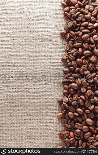 Coffee beans on burlap background with copyspace. Coffee beans on burlap background