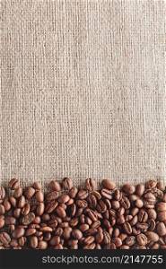 Coffee beans on burlap background with copyspace. Coffee beans on burlap background