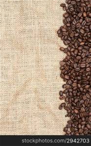 Coffee beans on hessian background as a border