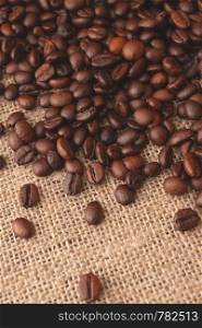 Coffee beans on old burlap background. Coffee beans on burlap background