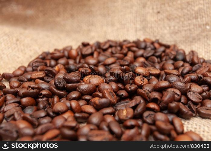 Coffee beans on old burlap background. Coffee beans on burlap background