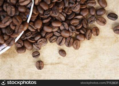Coffee beans roasted on rustic wood background