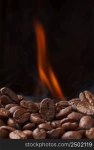 Coffee beans roasting with fire and smoke