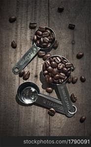 Coffee Beans with scoop on wooden table. Coffee Beans with scoop
