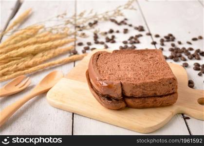 Coffee Bread and Coffee Bean for breakfast on wooden background