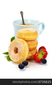 Coffee break with fresh berries and sugary donuts over white background