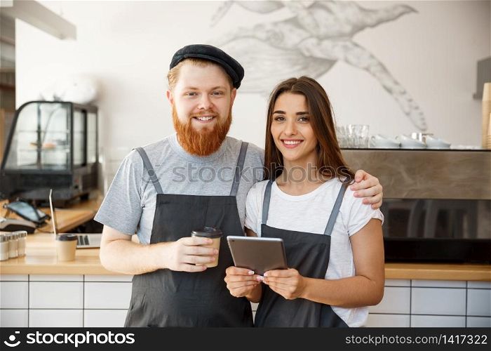 Coffee Business Concept - Portrait of small business partners standing together at their coffee shop