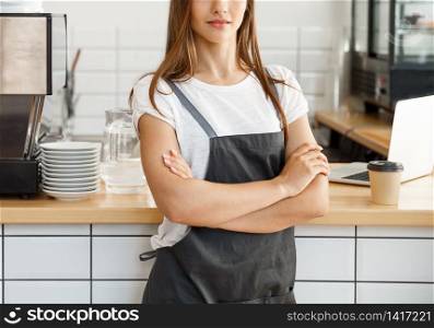 Coffee Business owner Concept - attractive young beautiful caucasian barista in apron with confident looking at camera in coffee shop counter.