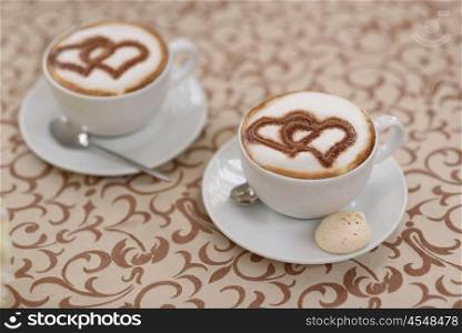 coffee cappuccino with hearts on the table