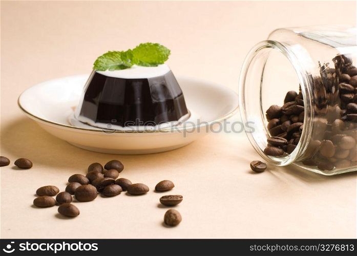 Coffee, coffee pudding and coffee beans in glass jar