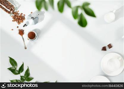 Coffee composition on light grey background, window shadow and green branches, flat lay, top view