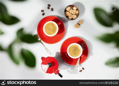 Coffee composition on light grey background with green branches, flat lay, top view