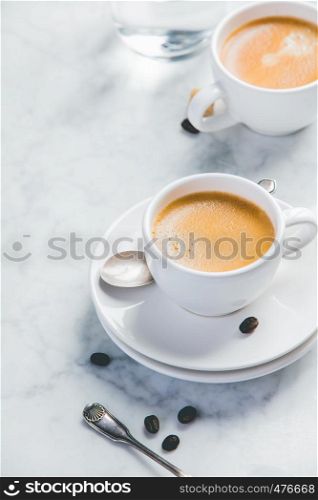 Coffee composition on white marble background. Coffee composition on white marble background. Coffee espresso in white cups