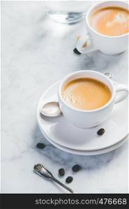 Coffee composition on white marble background. Coffee composition on white marble background. Coffee espresso in white cups