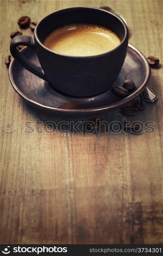 coffee cup against wooden background