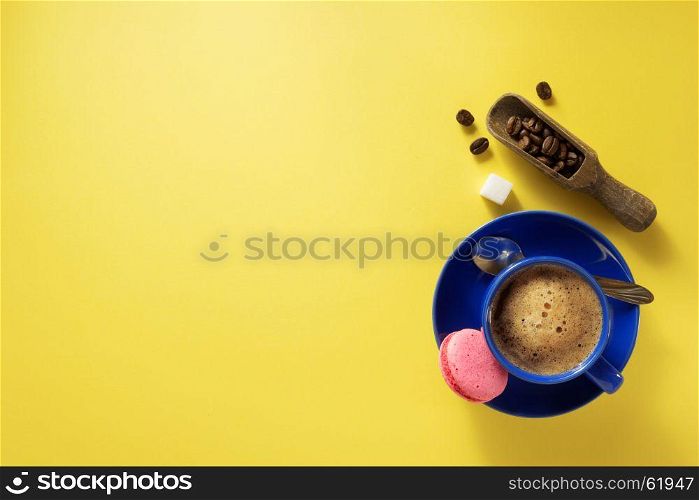 coffee cup and beans at blue paper background