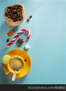 coffee cup and beans at blue paper background