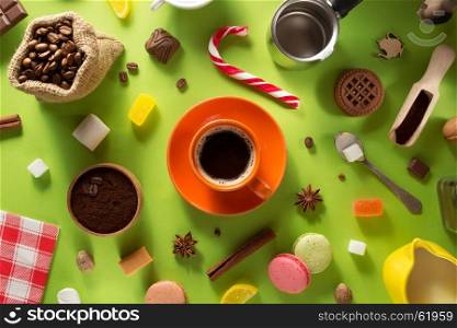 coffee cup and beans at green paper background