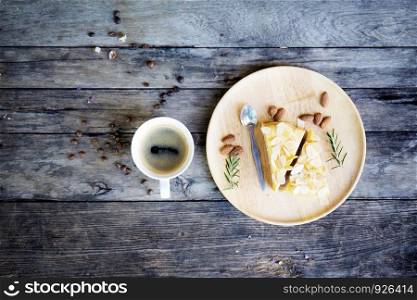 Coffee cup and cake on table with top view background.